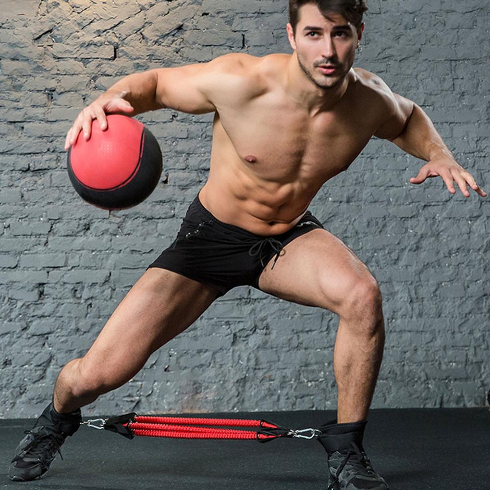 man using resistance bands and dribbling ball