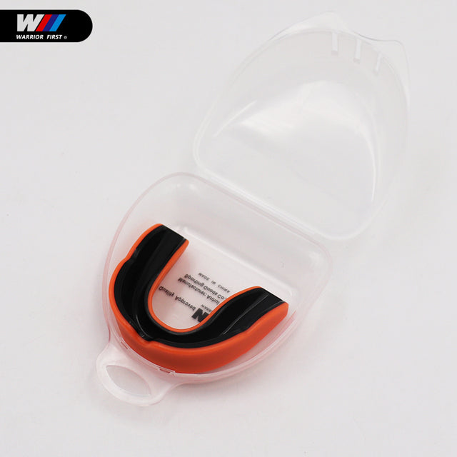 black and orange mouth guard with clear case and white background