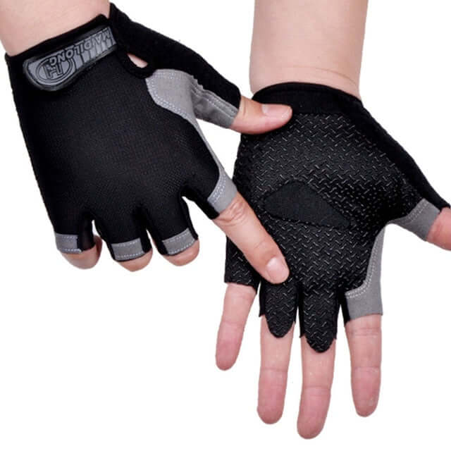 hands wearing black, and gray half finger cycling gloves with white background
