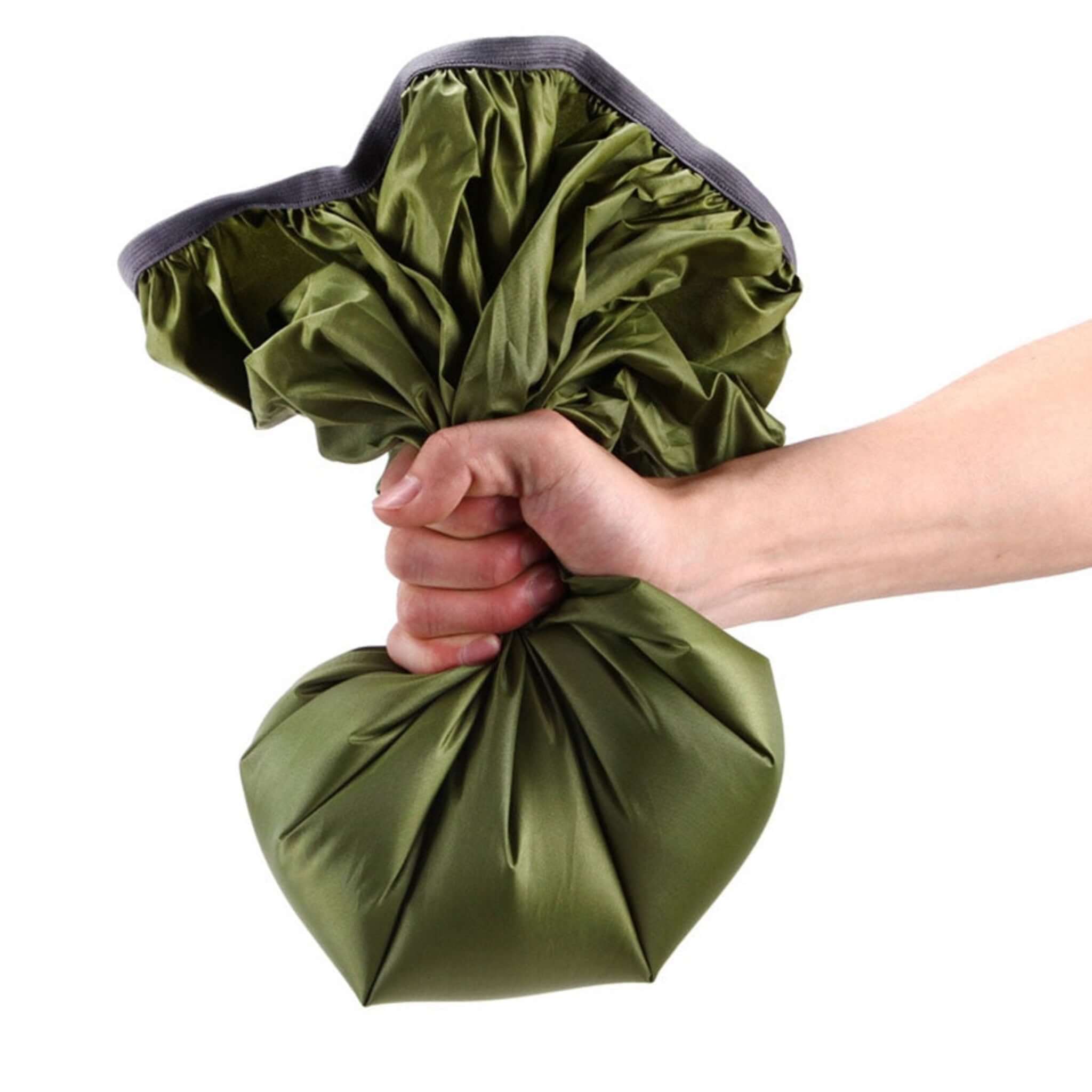 person squeezing green backpack rain cover with white background