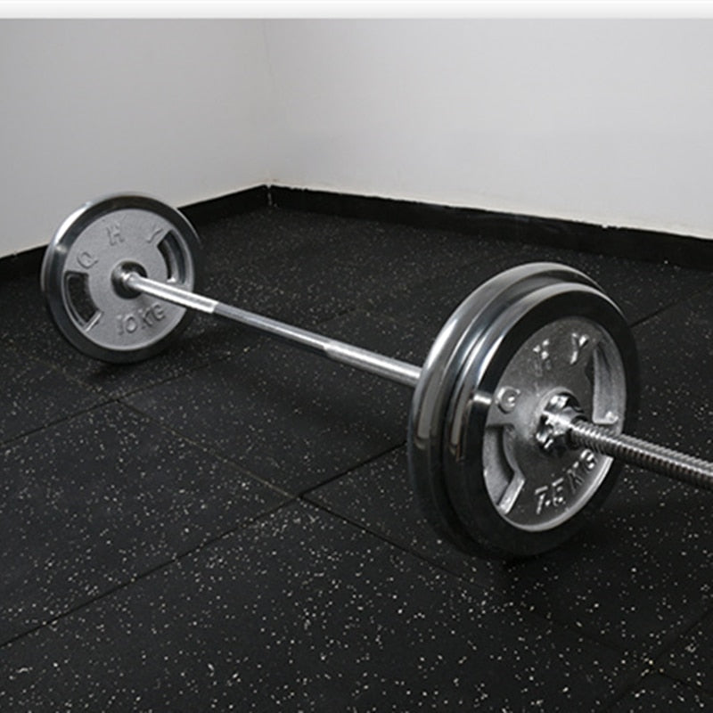 barbell on black floor and white walls in the background