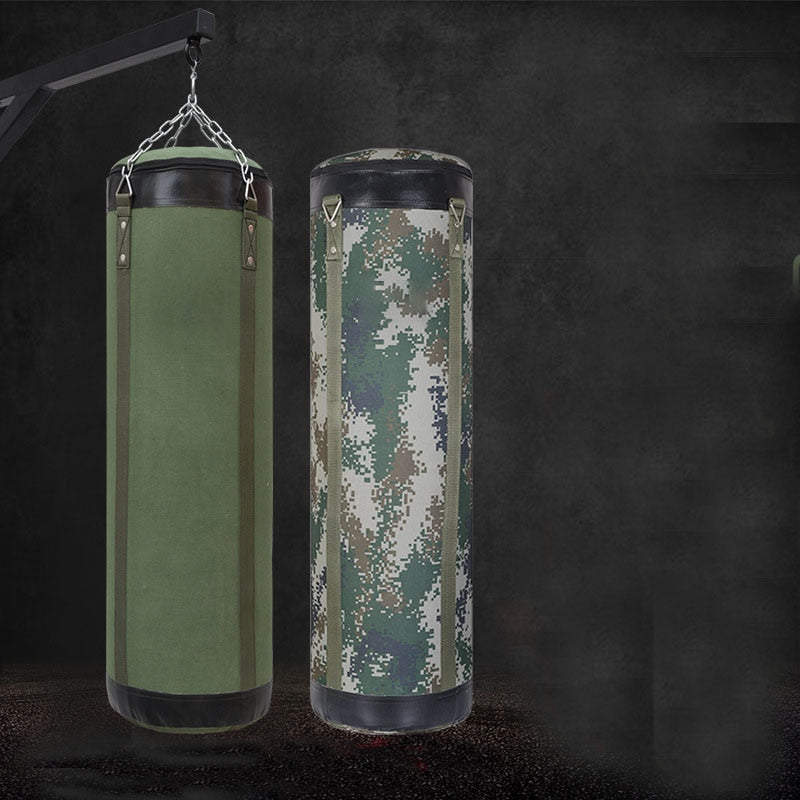 green punching bag hanging next to camouflage punching bag and black background 