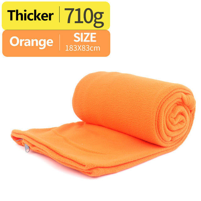 orange sleeping bag with white background