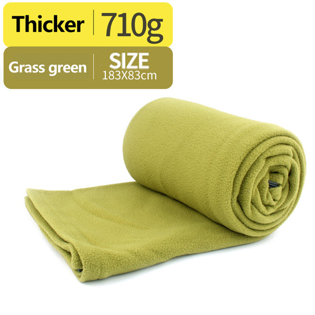 green sleeping bag with white background