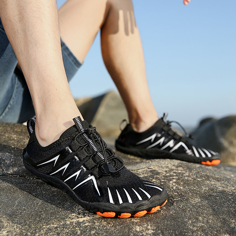 man wearing black, white, and orange water shoes